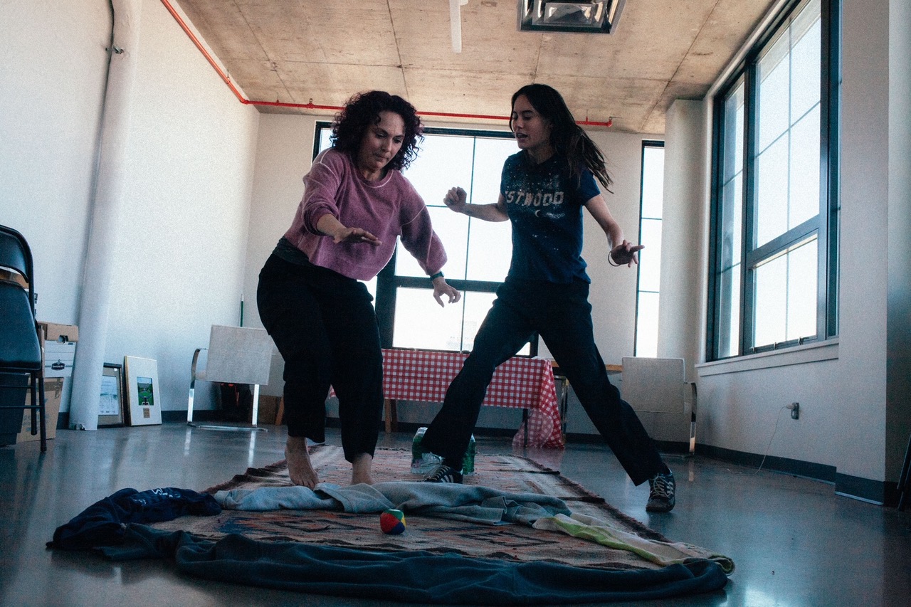 Meg jumping with another actor